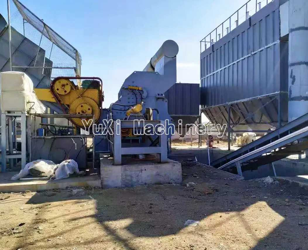 Exterior view of recycling or scrap processing machinery with conveyors and a large storage/filtration unit.